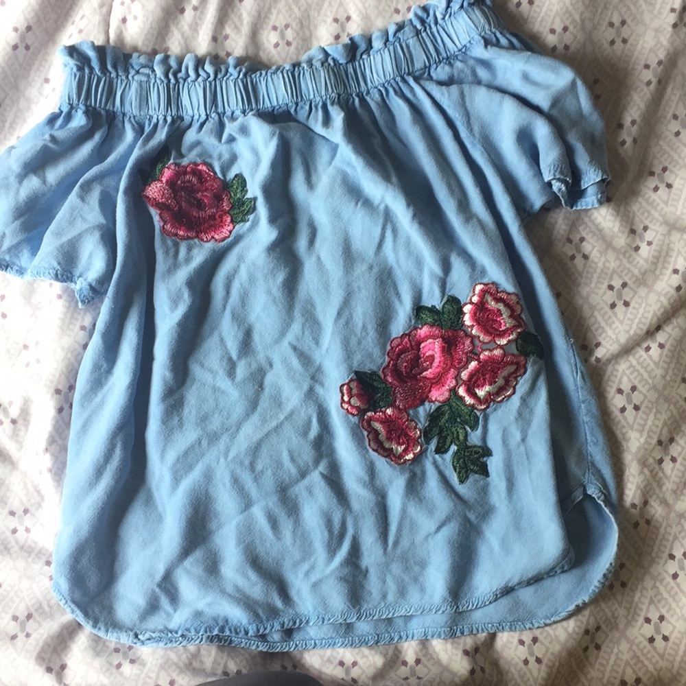 A blue medium sized, off the shoulder shirt